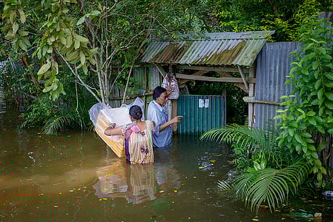 Tripura Floods: People wade through a flood-affected area at Amarpur